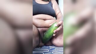 Hot mother playing with a cucumber